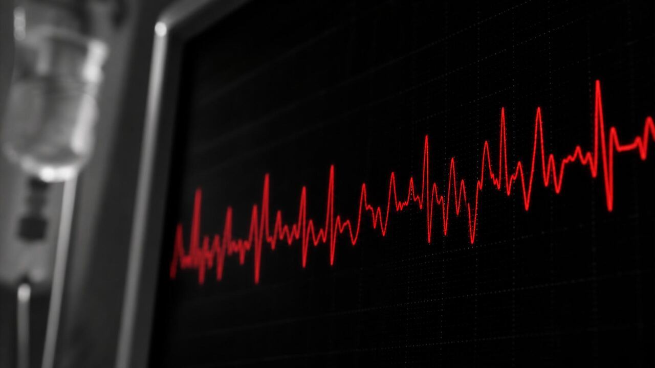 Close-up of a cardiac monitor in a dark hospital room